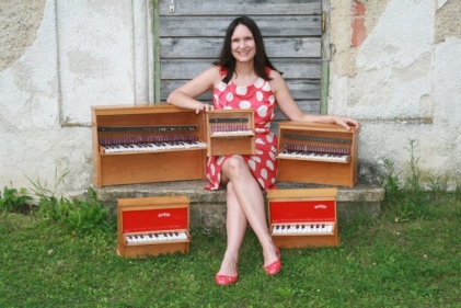 Isabel with her collection of Michelsonne toy pianos